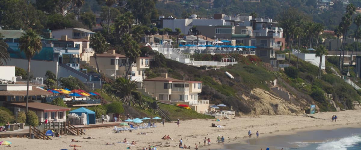 Laguna Beach featuring a coastal town, landscape views and a sandy beach