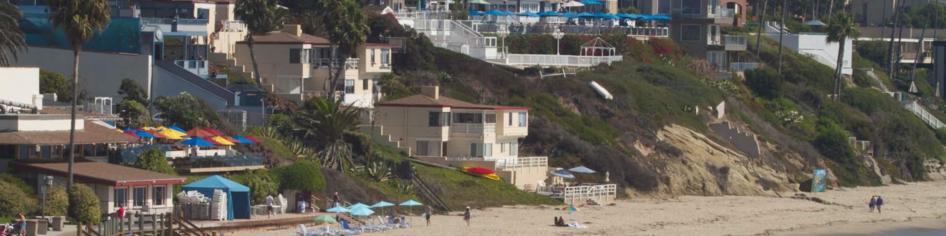 Laguna Beach showing landscape views, a sandy beach and a coastal town
