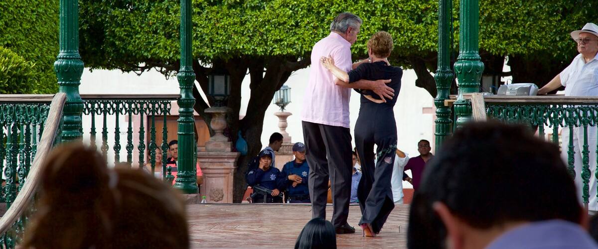Mexico showing performance art as well as a small group of people