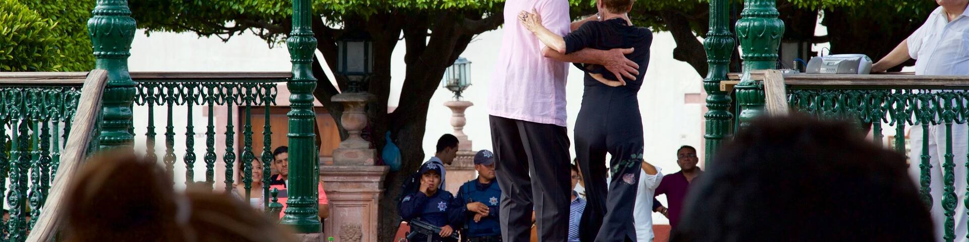 Mexico showing performance art as well as a small group of people