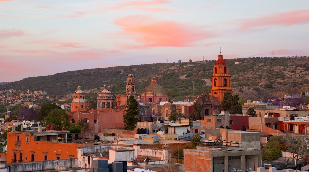 San Miguel de Allende showing heritage architecture, a sunset and a church or cathedral