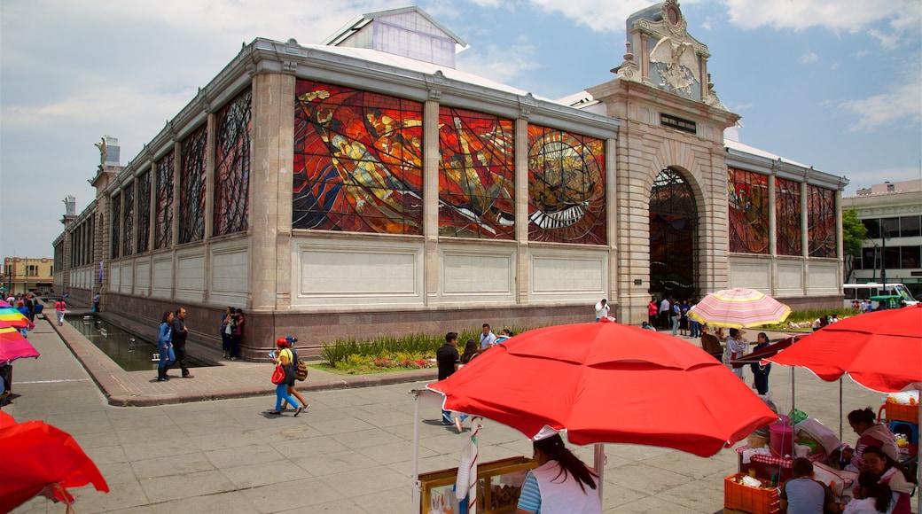 The Cosmovitral which includes a square or plaza and heritage architecture as well as a small group of people