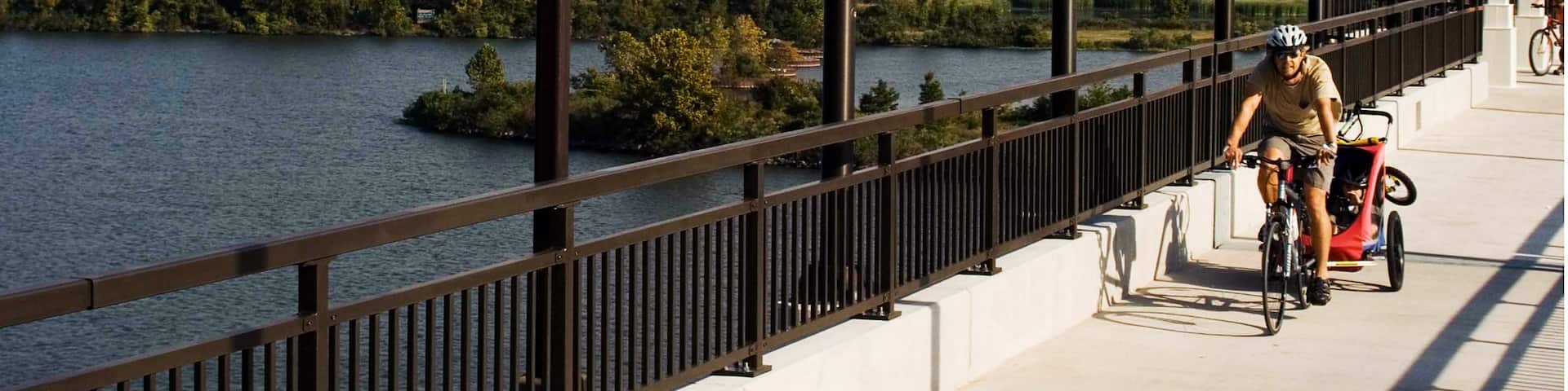 Big Dam Bridge which includes cycling, a bridge and a lake or waterhole