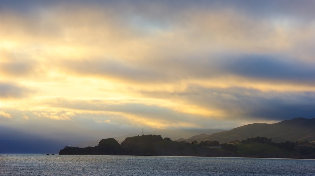 China Beach which includes landscape views, a sunset and a lake or waterhole