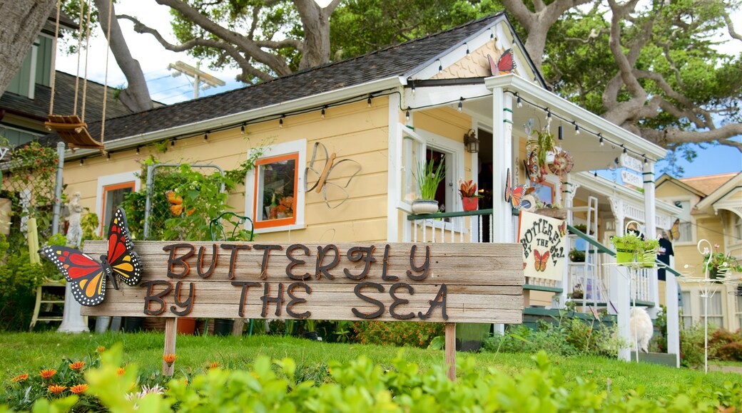 Pacific Grove featuring signage and a house