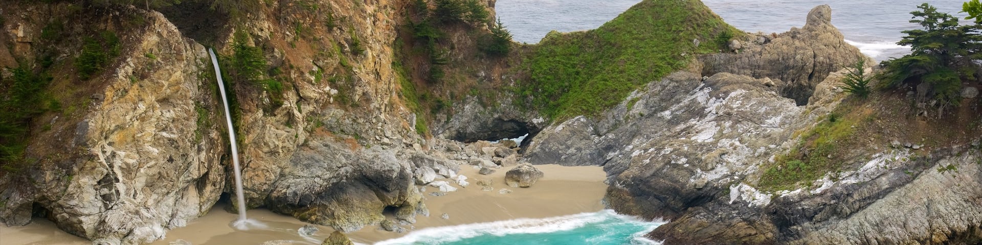 McWay Falls featuring rocky coastline, a beach and a bay or harbor