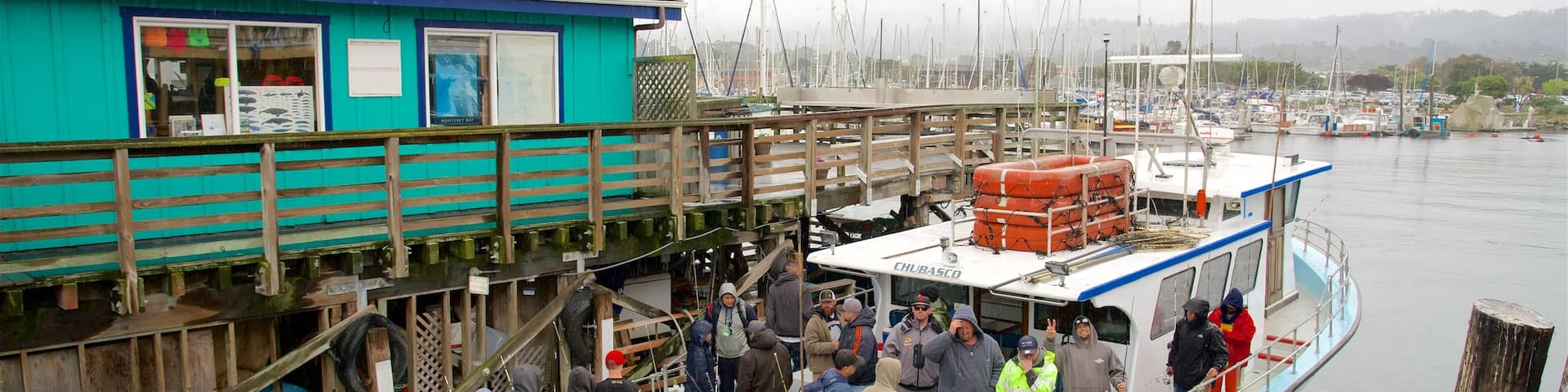 Fisherman\'s Wharf featuring boating and general coastal views as well as a large group of people