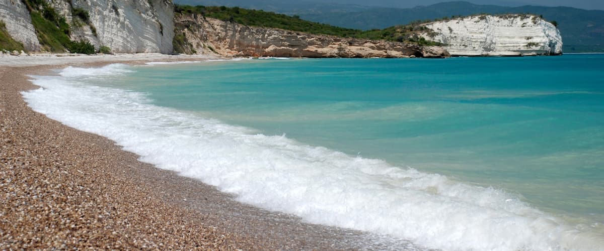 Haiti featuring a pebble beach and rocky coastline