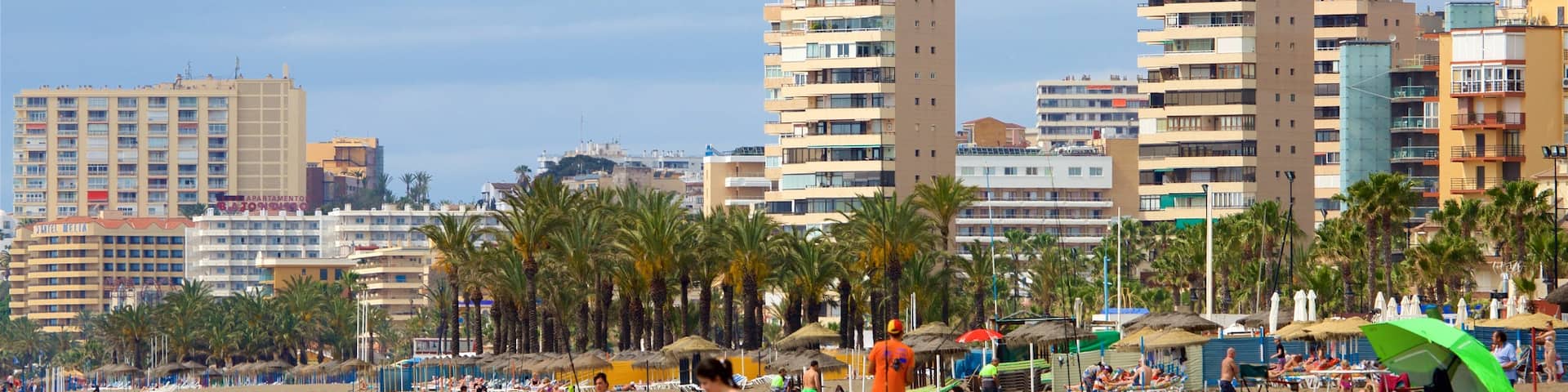 Los Alamos Beach which includes a city and a sandy beach as well as a large group of people