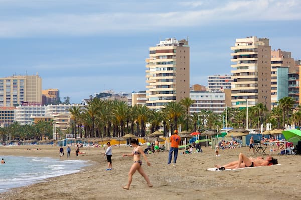 Los Alamos Beach which includes a city and a sandy beach as well as a large group of people