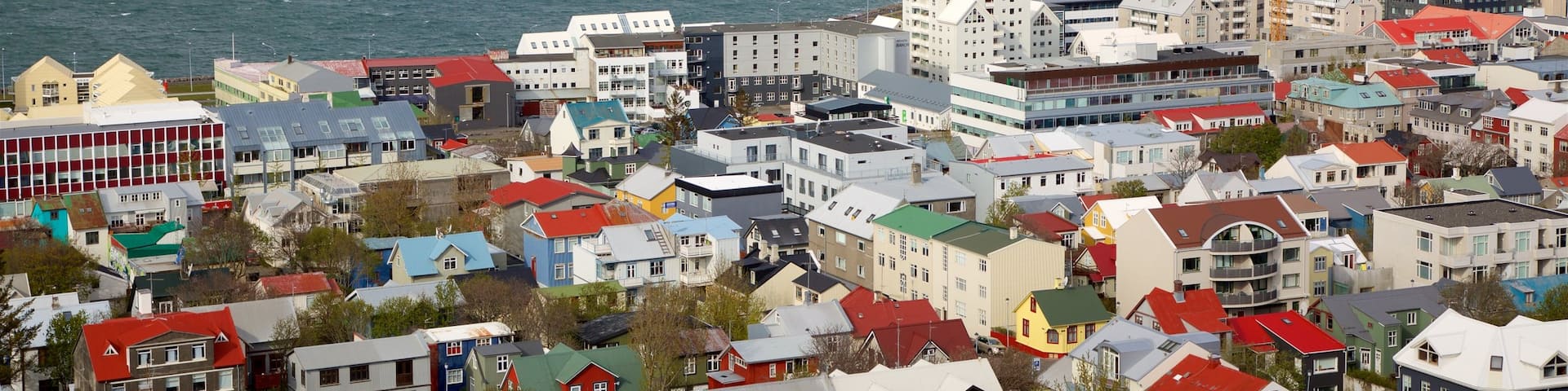 Reykjavik showing mountains, a coastal town and general coastal views