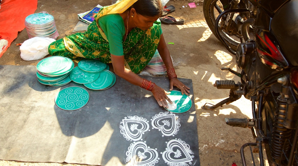 Sai Baba Temple showing outdoor art as well as an individual female