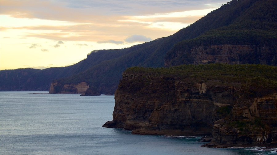 Tasman Peninsula featuring rocky coastline, landscape views and a sunset