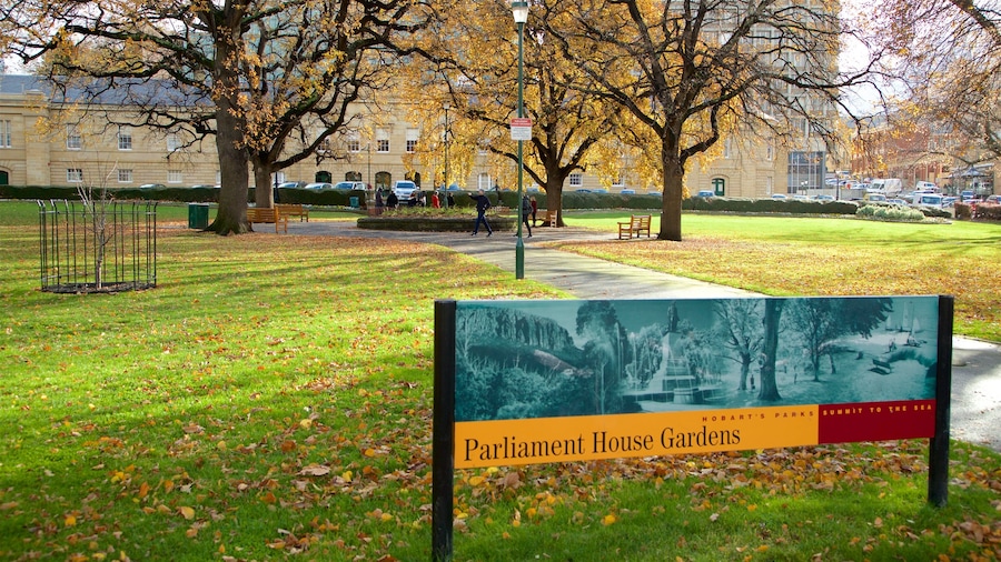 Parlamentsbygningen som viser skiltning, efterårsfarver og en park