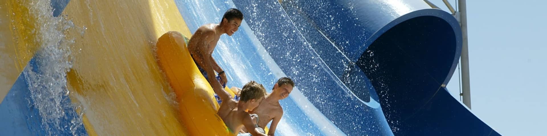 Six Flags Hurricane Harbor featuring a waterpark as well as a small group of people