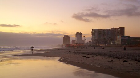 Rosarito which includes general coastal views, a sunset and a beach