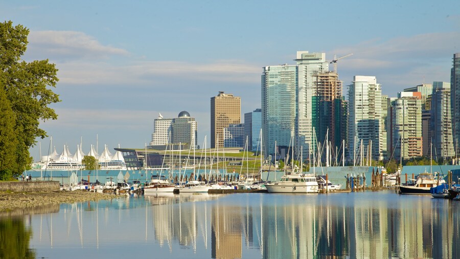 Waterfront view of the Seawall with Vancouver skyline and marina in the background.