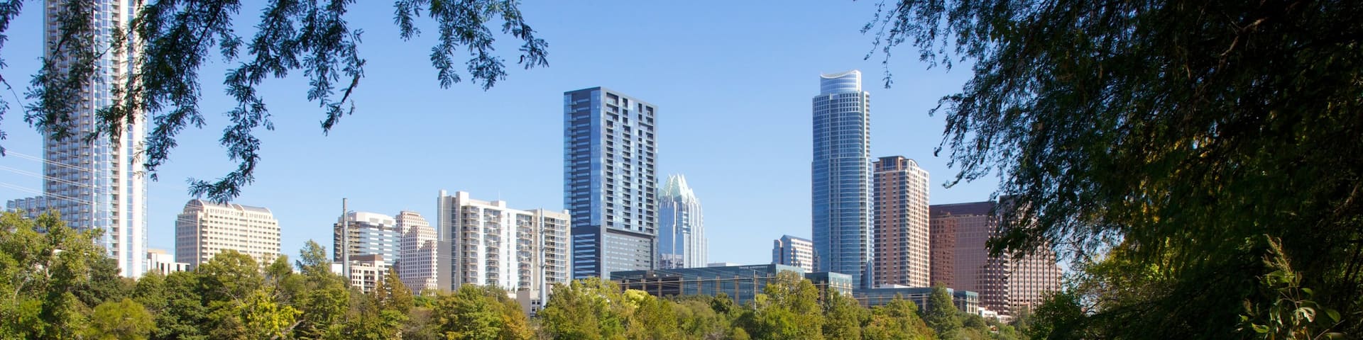 Lady Bird Lake showing landscape views, a lake or waterhole and a skyscraper