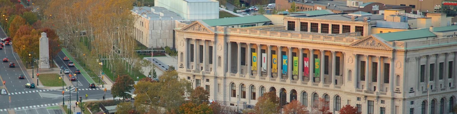 Cityscape view of Philadelphia showcasing autumn foliage and municipal architecture near a fountain