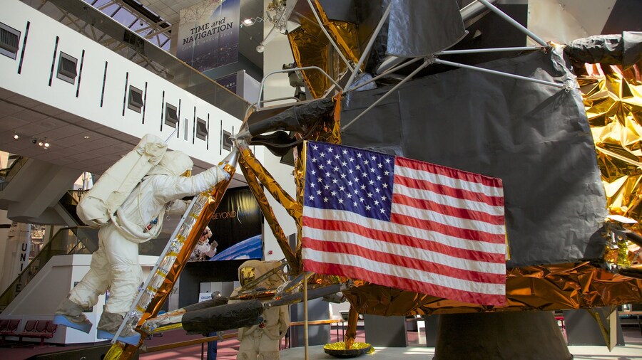 Apollo 11 exhibit with astronaut figure and American flag at the Smithsonian National Air and Space Museum.