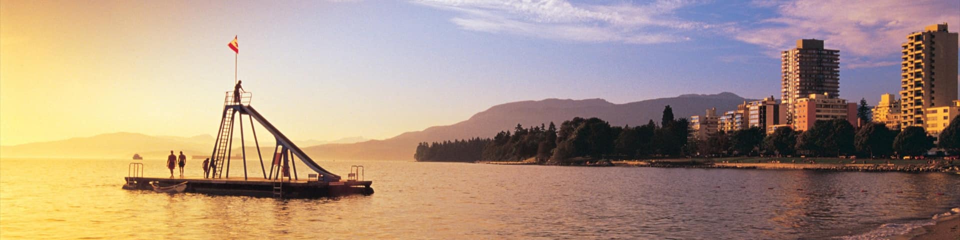 English Bay Inukshuk which includes landscape views, a beach and a sunset