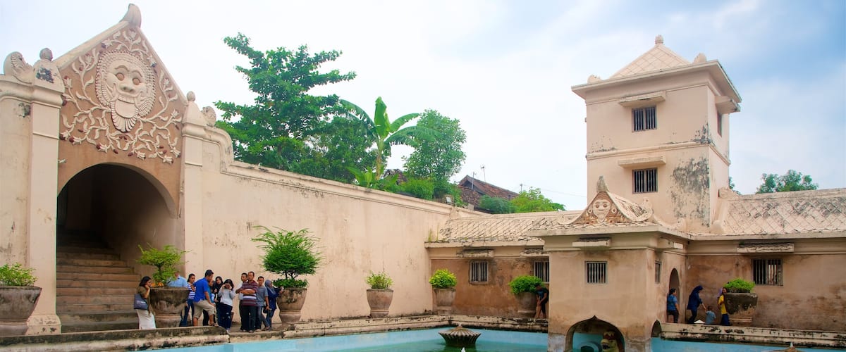 Water Castle which includes heritage architecture and a pool as well as a small group of people