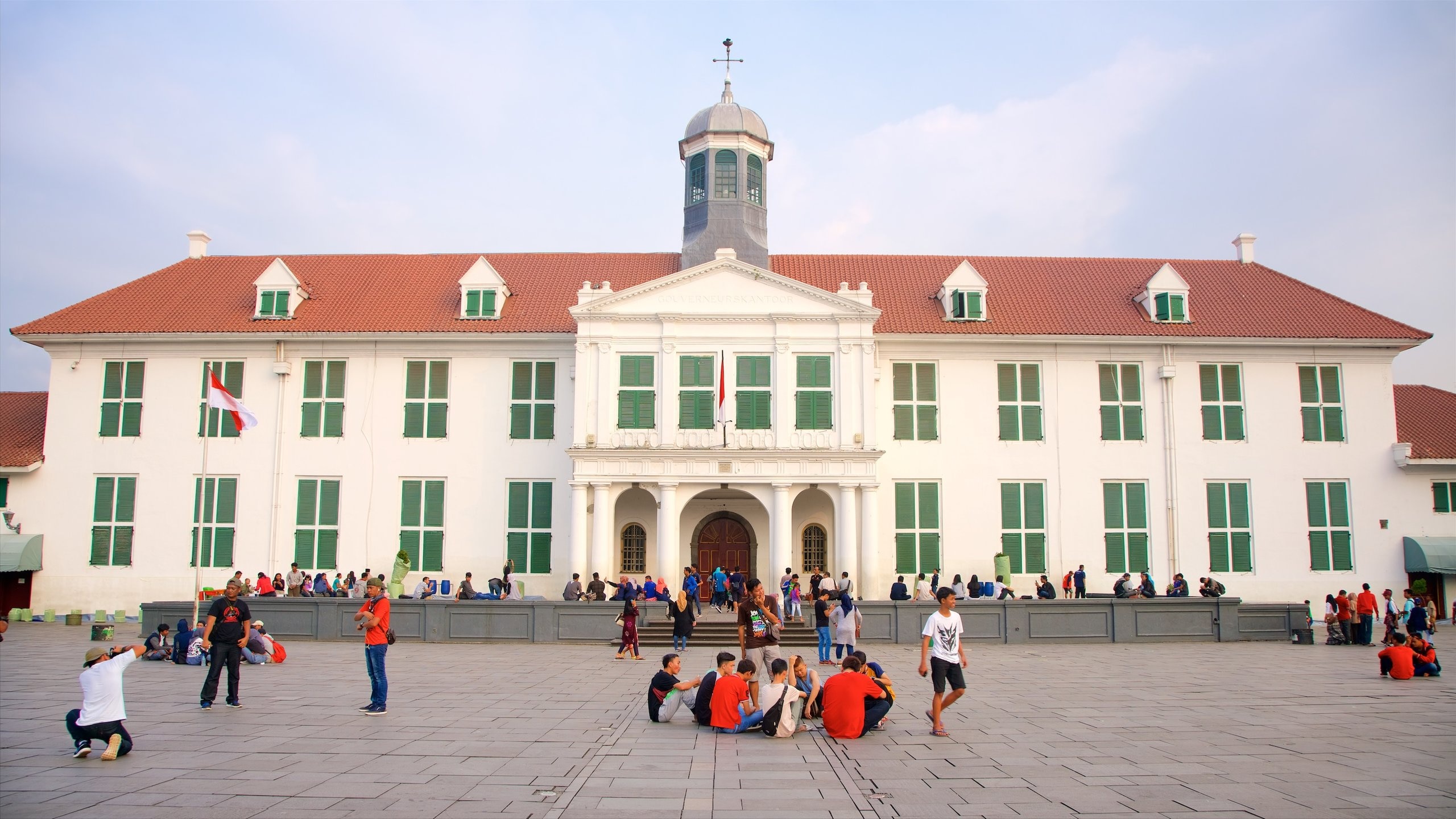 Jakarta History Museum showing heritage architecture and a square or plaza as well as a small group of people