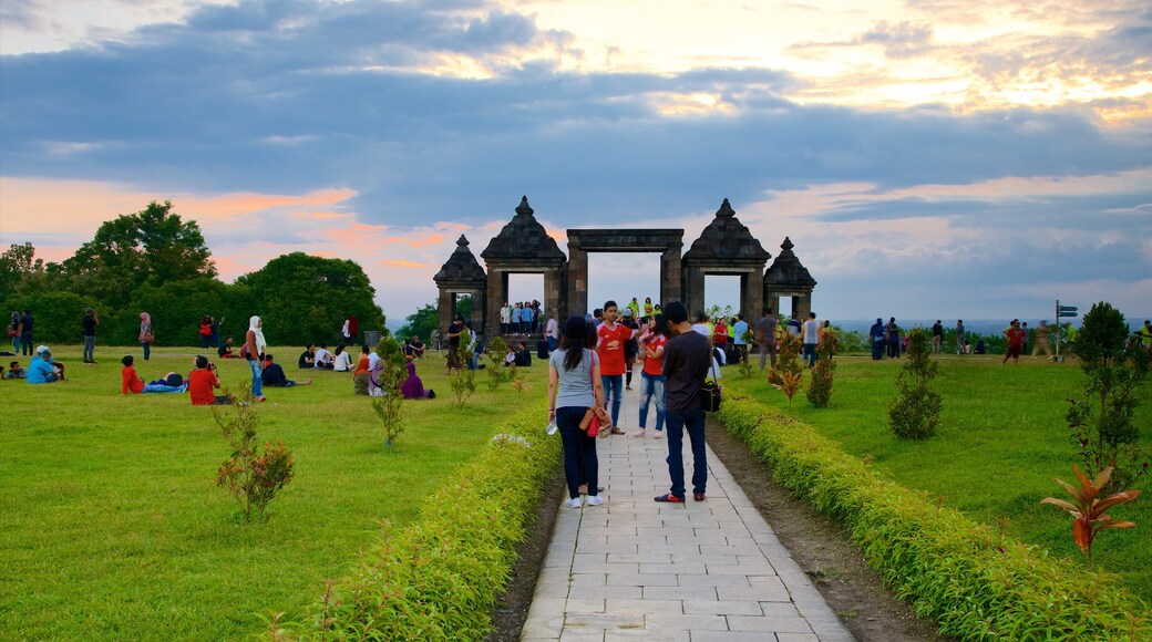 Ratu Boko Palace featuring heritage elements and a park as well as a small group of people