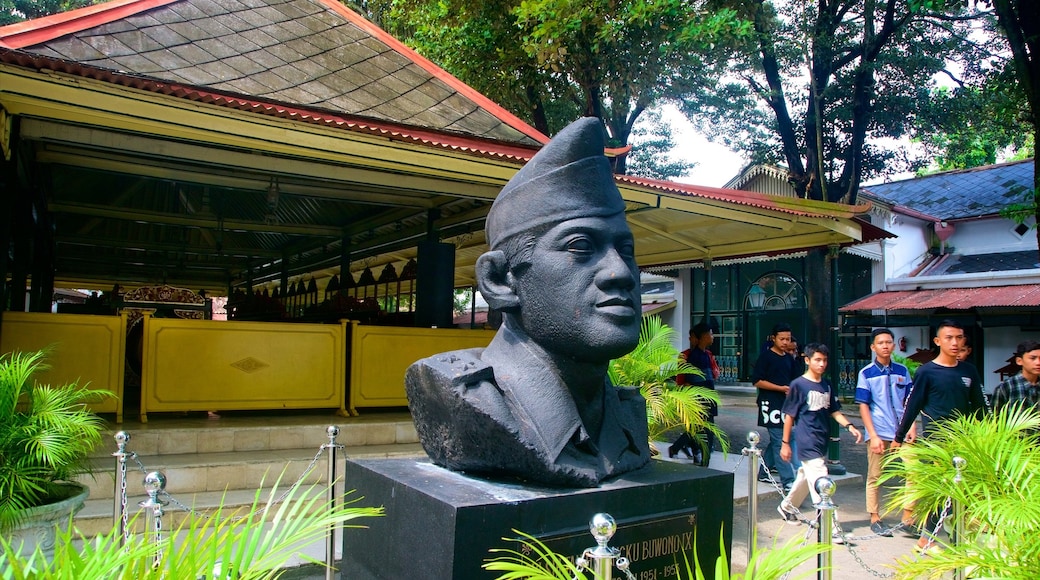 Kraton Complex showing a statue or sculpture as well as a small group of people