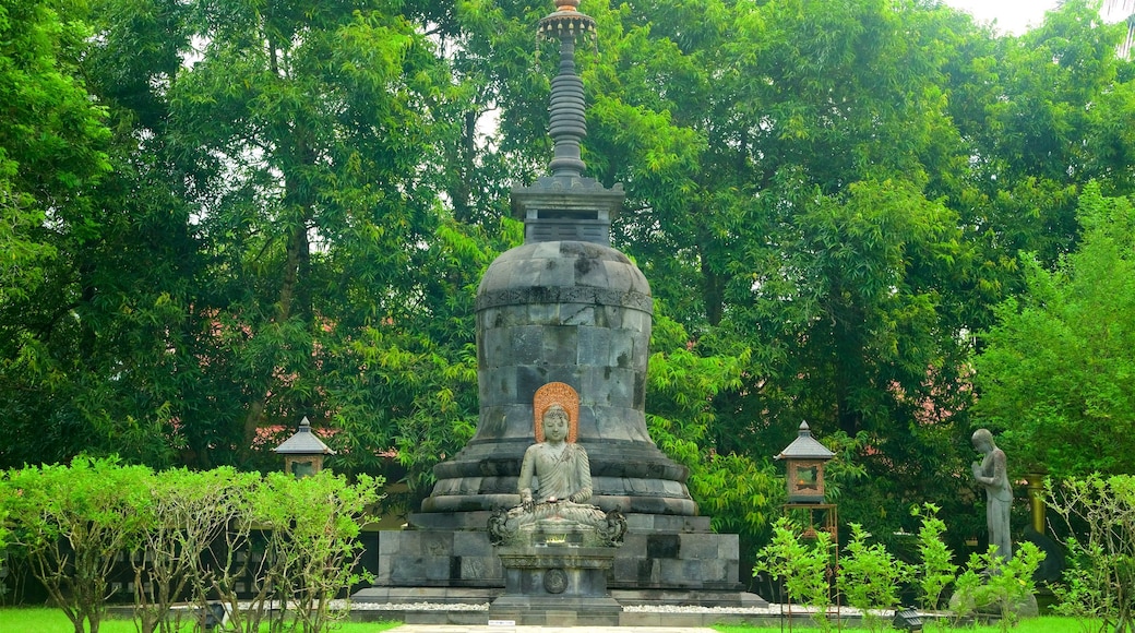 Mendut Buddhist Monastery featuring a fountain and a garden