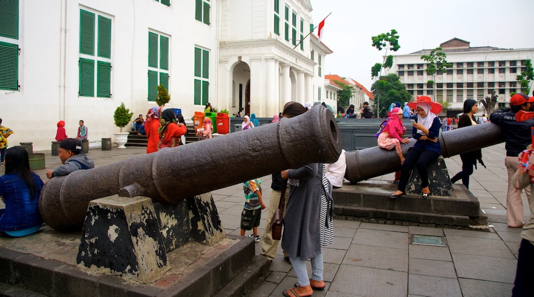 Old Jakarta featuring a square or plaza and military items as well as a small group of people