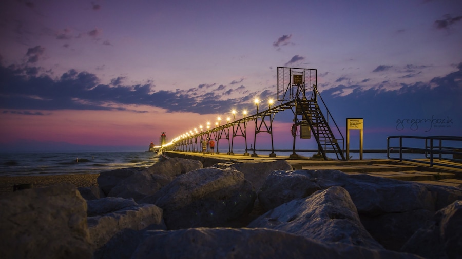 Grand Haven which includes a sunset and rocky coastline