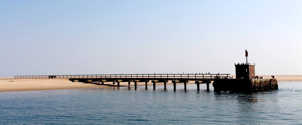 Pelican Point Lighthouse showing a beach and general coastal views