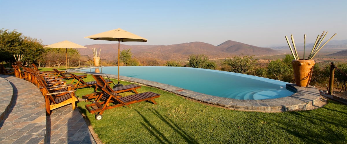 Opuwo showing desert views, tranquil scenes and a pool
