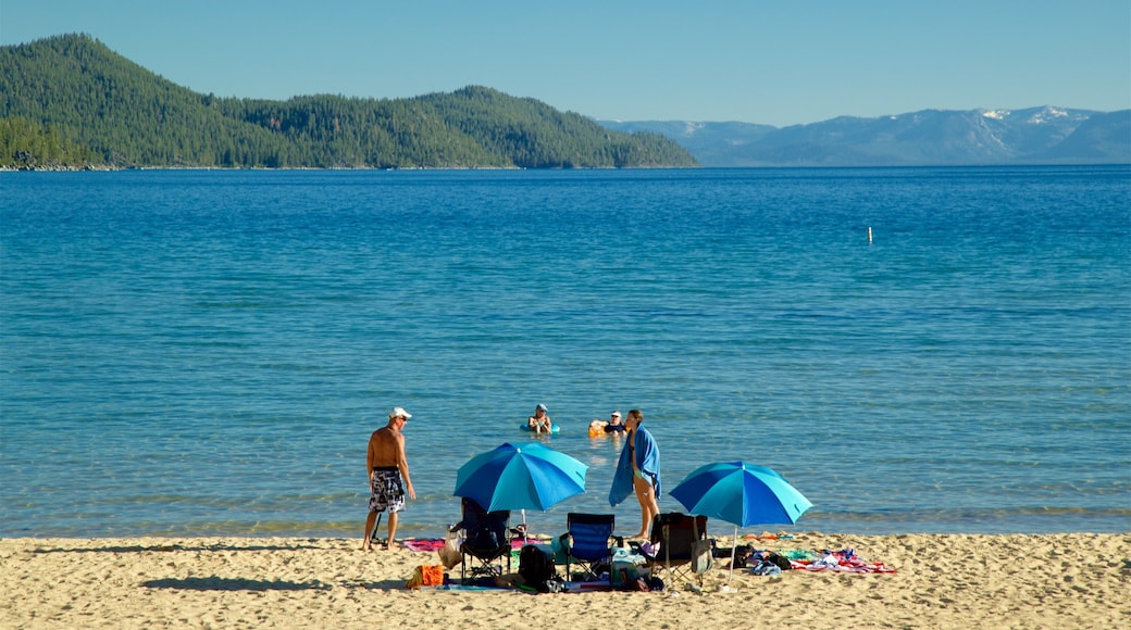 Sand Harbor of Lake Tahoe Nevada State Park showing a sandy beach and general coastal views as well as a small group of people