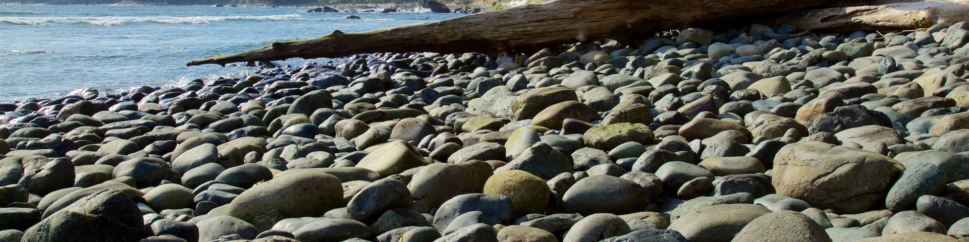 Victoria featuring a lake or waterhole and a pebble beach
