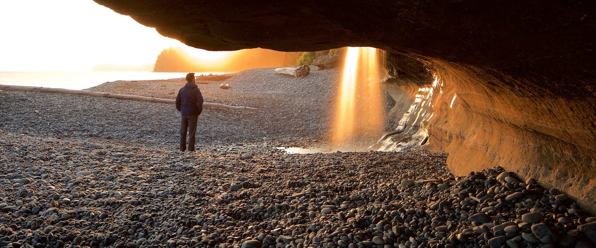 Sooke featuring a sunset and a pebble beach as well as an individual male