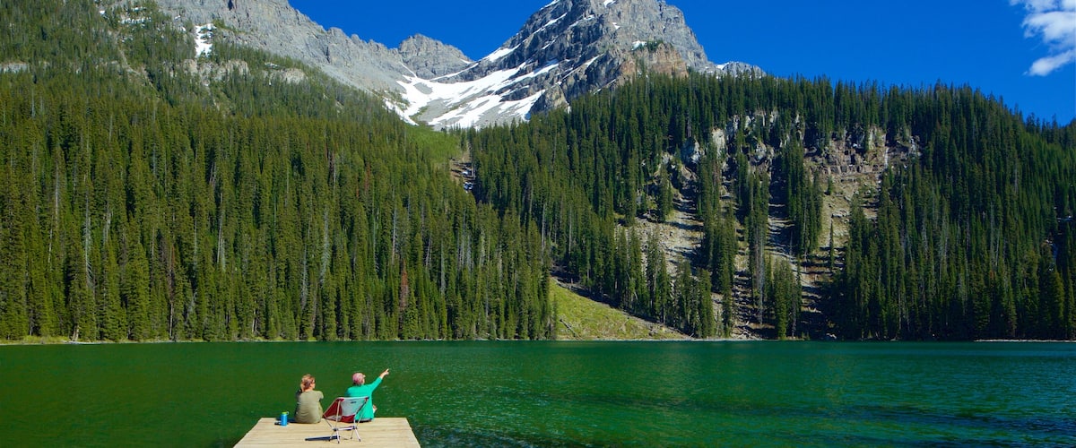 Top of the World Provincial Park featuring a lake or waterhole and tranquil scenes as well as a couple