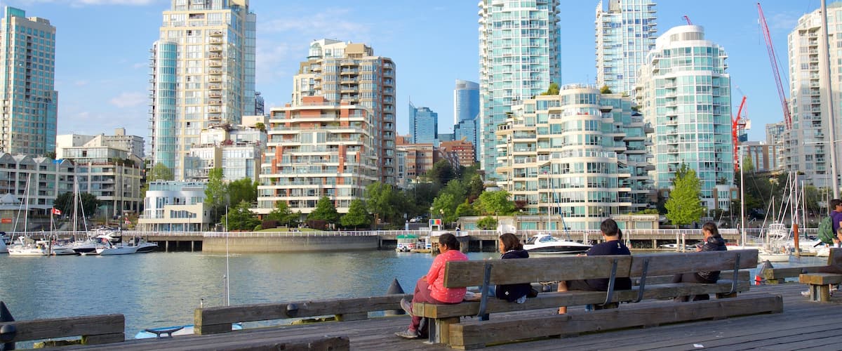 Granville Island which includes a bay or harbor and a city as well as a small group of people