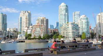 Granville Island which includes a bay or harbor and a city as well as a small group of people