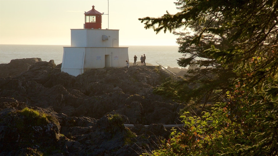 Amphitrite Point Lighthouse which includes a sunset, rugged coastline and general coastal views