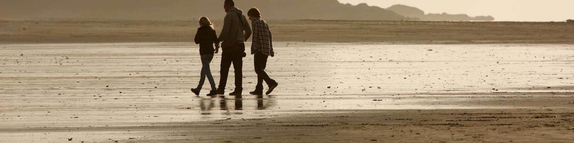 Chesterman Beach featuring general coastal views and a sunset as well as a small group of people