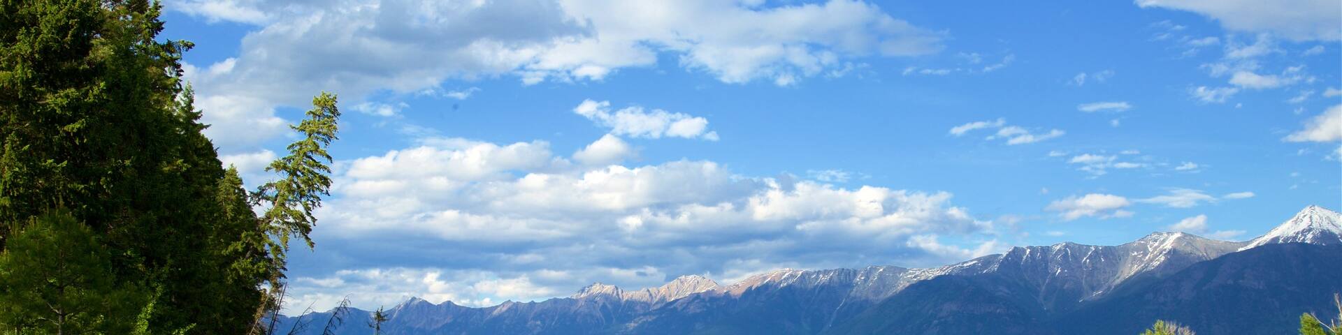 Skookumchuck which includes a lake or waterhole, mountains and tranquil scenes