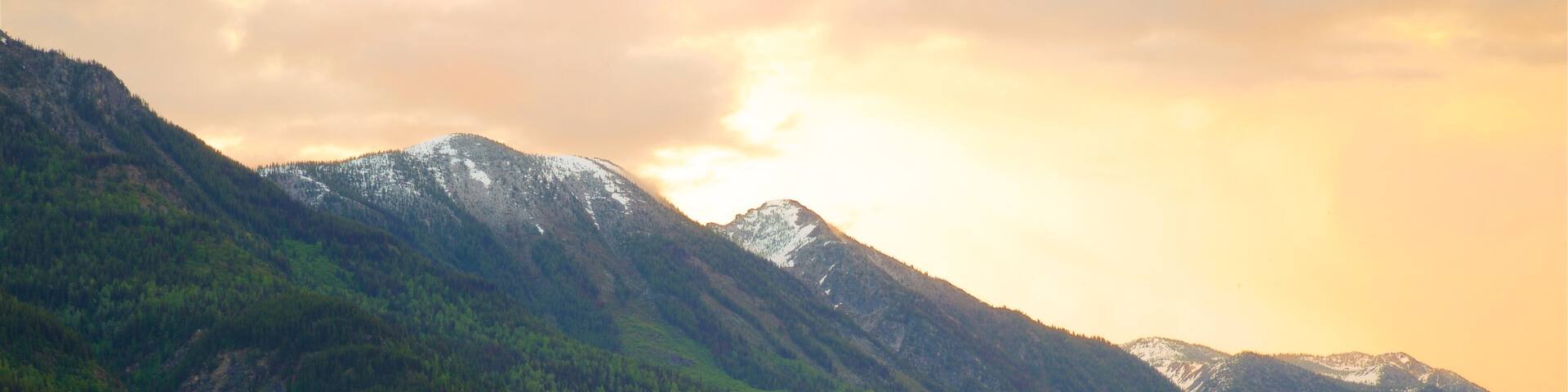 New Denver featuring tranquil scenes, a sunset and a lake or waterhole