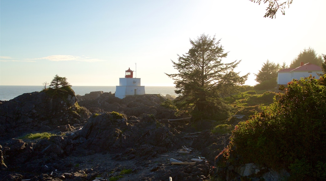 Amphitrite Point Lighthouse showing a sunset, rugged coastline and a lighthouse