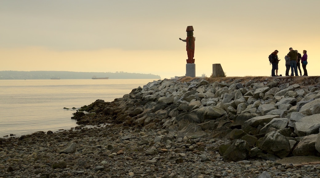 Ambleside Park which includes general coastal views, a pebble beach and a statue or sculpture