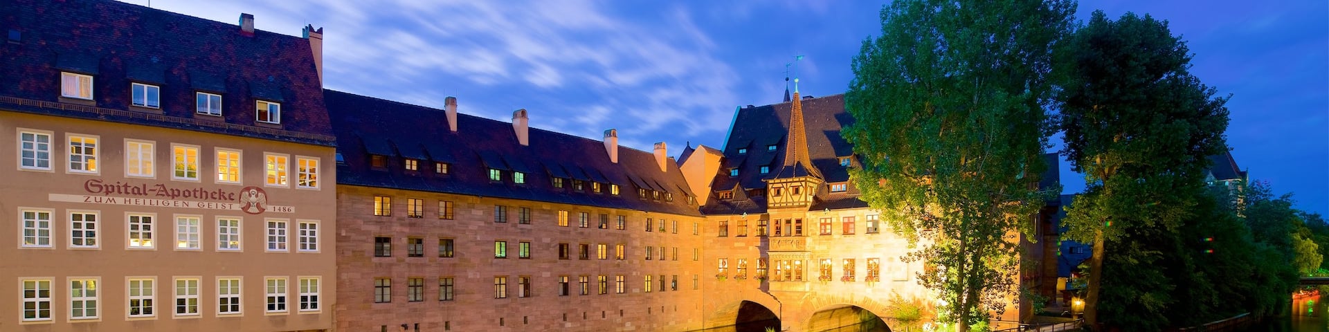 Heilig Geist Spital which includes heritage elements, a river or creek and a sunset