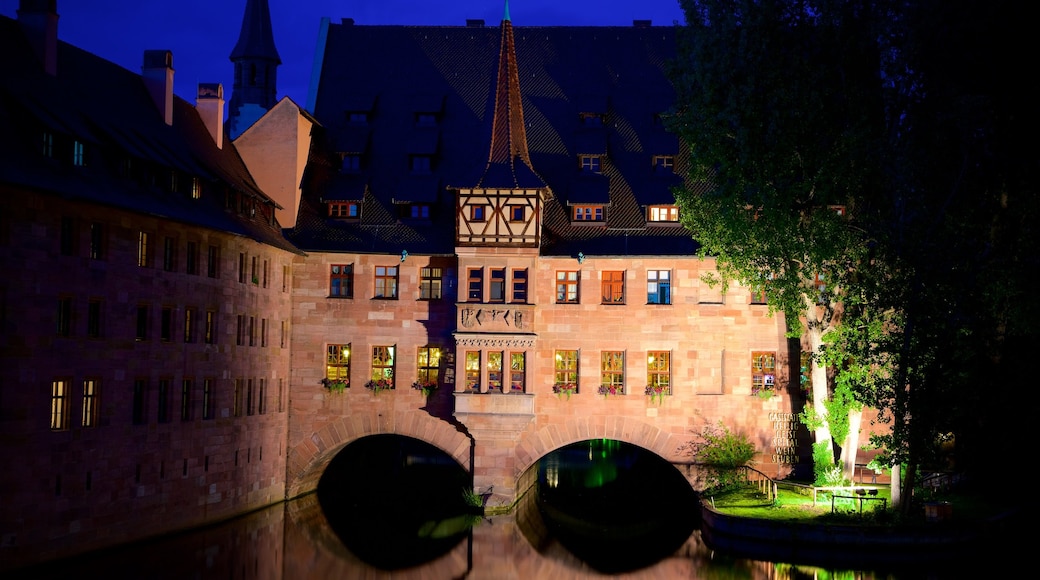 Heilig Geist Spital featuring heritage elements, night scenes and a river or creek