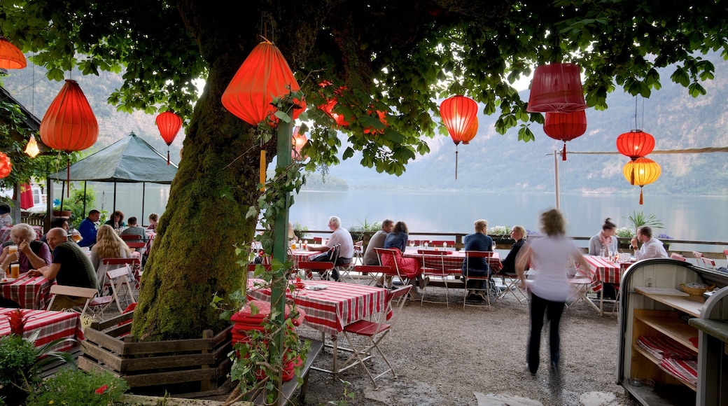 Upper Austria featuring a lake or waterhole and outdoor eating as well as a large group of people