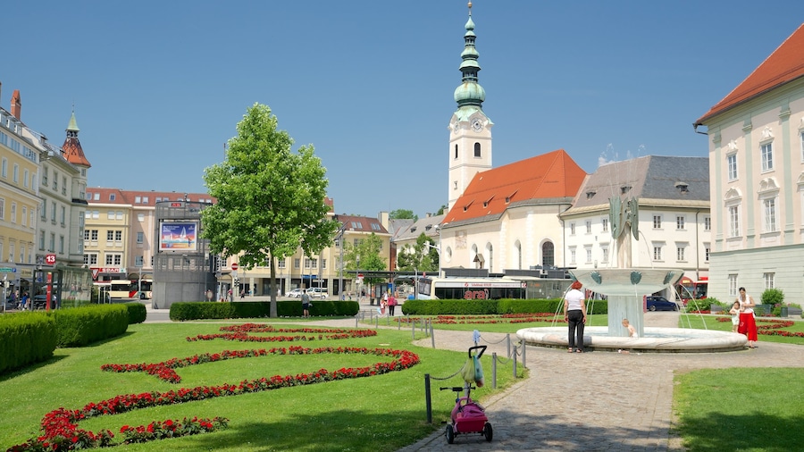 Klagenfurt am Woerthersee som omfatter blomster, en have og et springvand